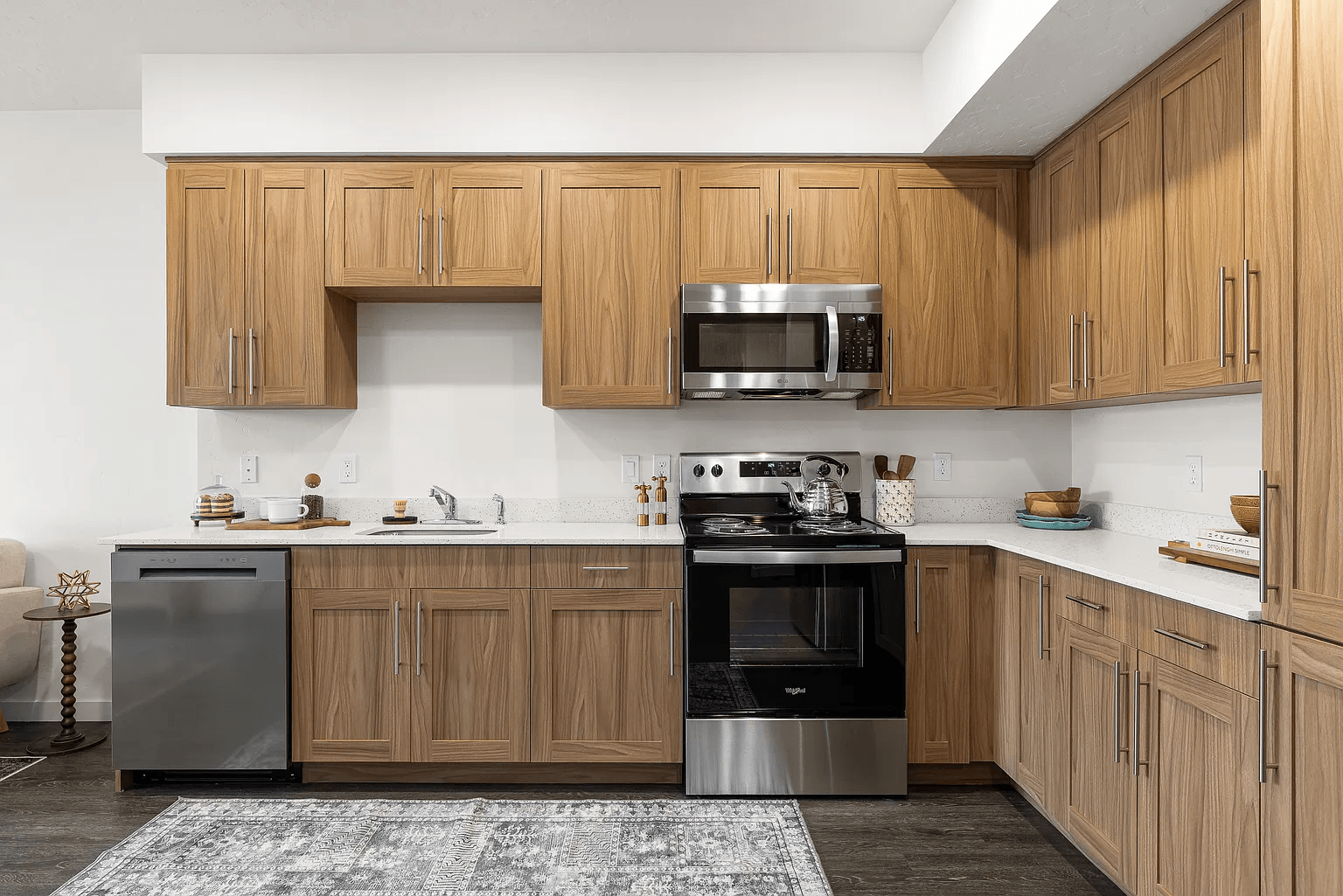 A kitchen with wooden cabinets and a range hood.